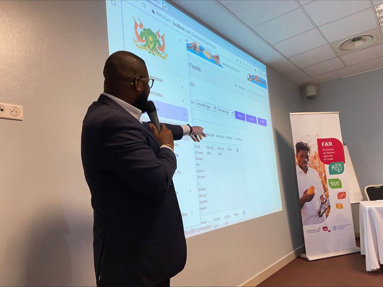 Eklin presenting a digital platform on a projected screen during a training session